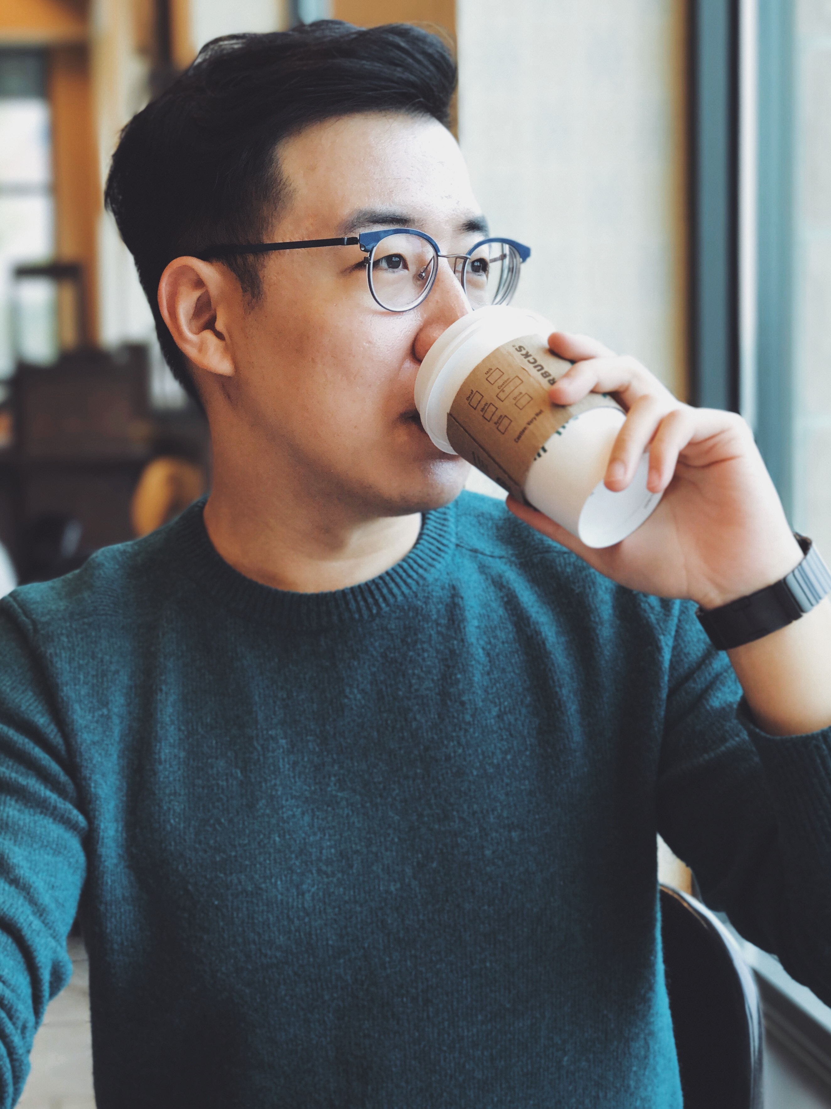 an asian man drinking coffee as he land jobs in Singapore in 2018